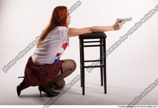 07 2018 01 TINA KNEELING POSE WITH GUNS